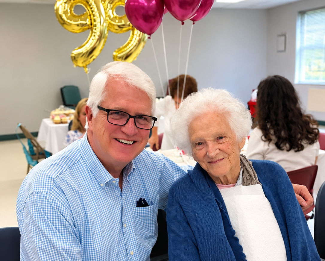 Resident smiling with a loved one during a birthday celebration at The Landmark Center in Stuart, Virginia