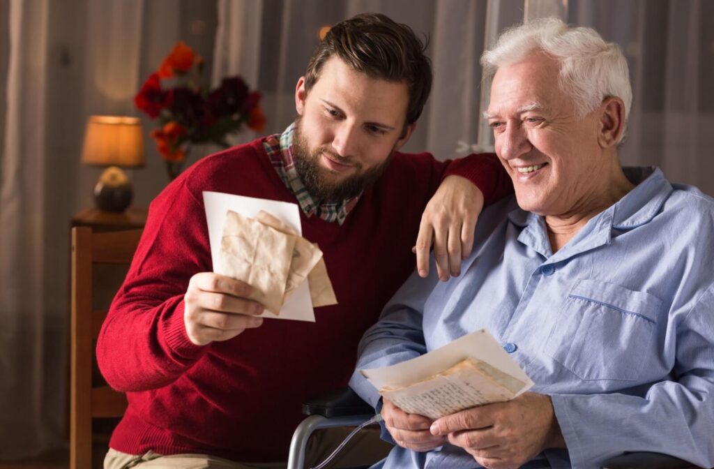 A senior with dementia shares old letters with their adult child as a means of connecting and holding onto their memories