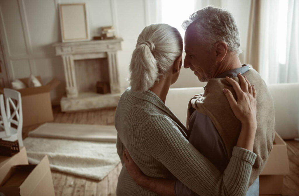  A couple embrace while taking a look around their old house during the final days before moving on to the next adventure