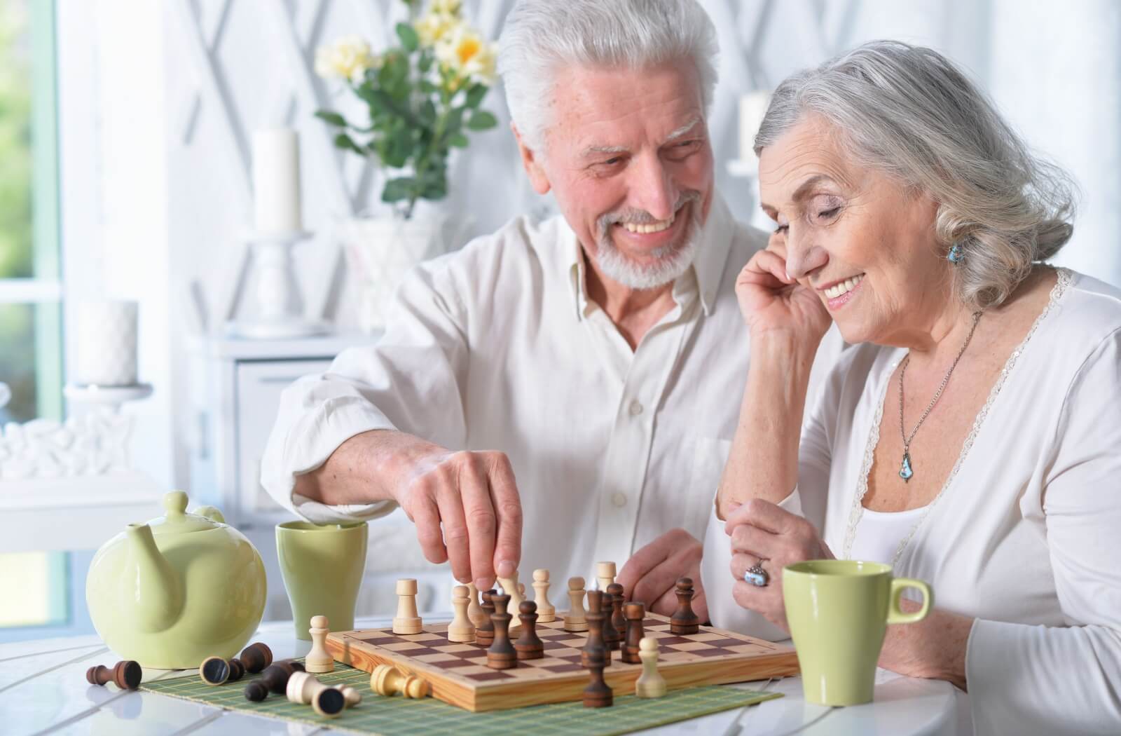 enior couple playing chess together